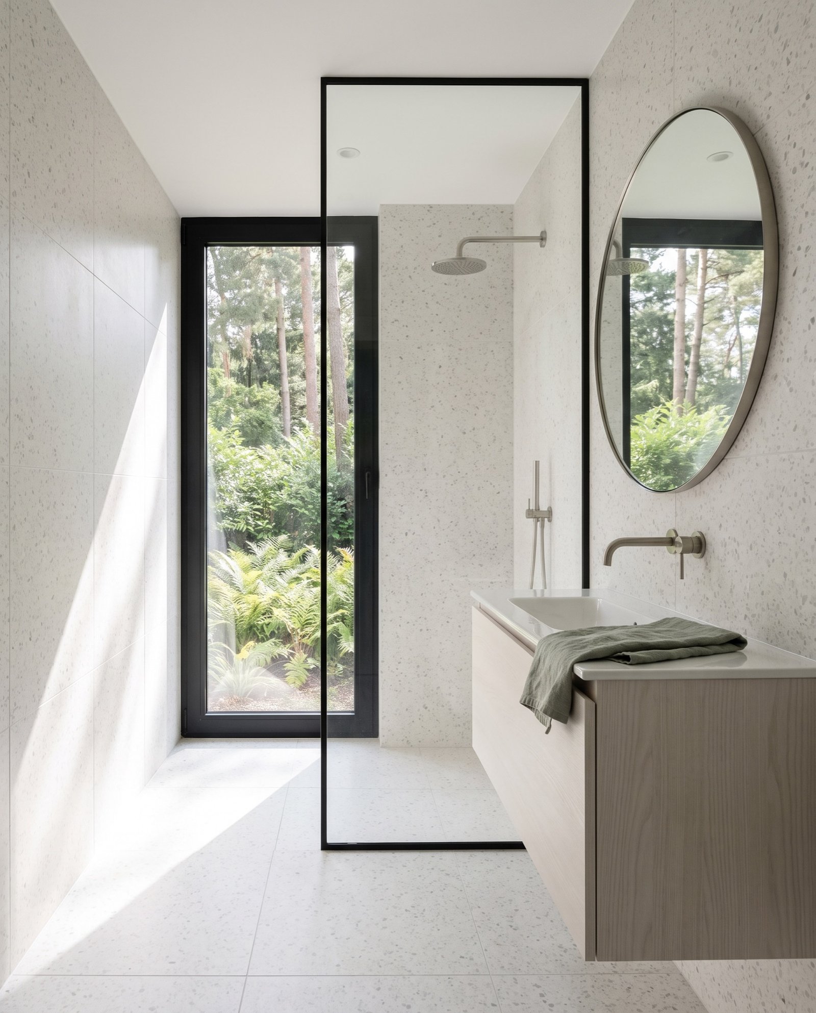 Bathroom in white terrazzo with an ash vanity and a window onto ferns