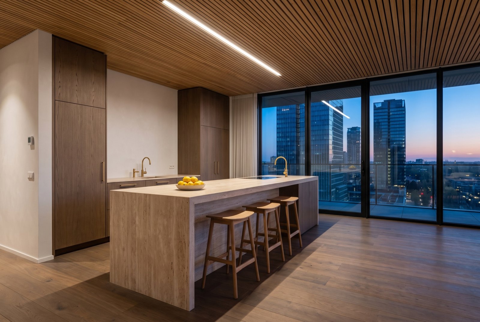 Kitchen with a travertine island, smoked oak cabinetry and brass tap in front of a glass wall