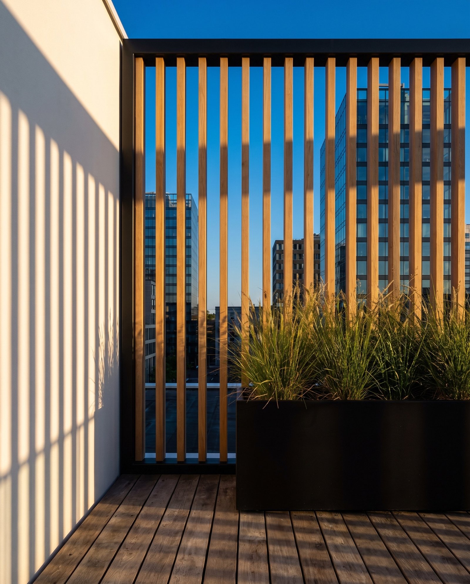 Oak slat screen on the roof terrace casting long shadows at golden hour